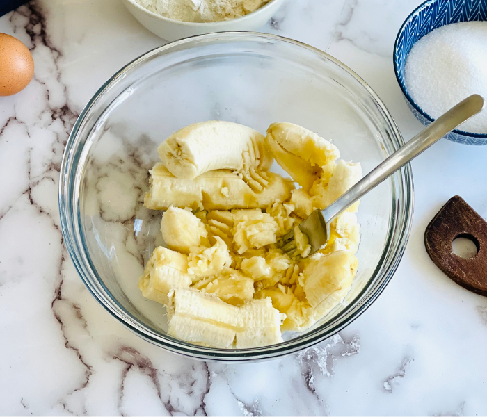 https://mirjamskitchenyodel.com banana bread mashing bananas