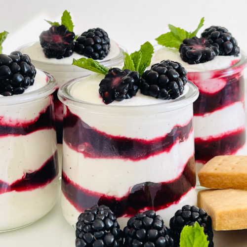 https://mirjamskitchenyodel.com blackberry fool garnished with blackberries and mint leave