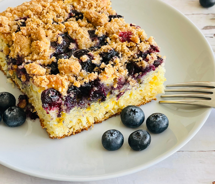 https://mirjamskitchenyodel.com blueberry pancake casserole close up on plate with fork