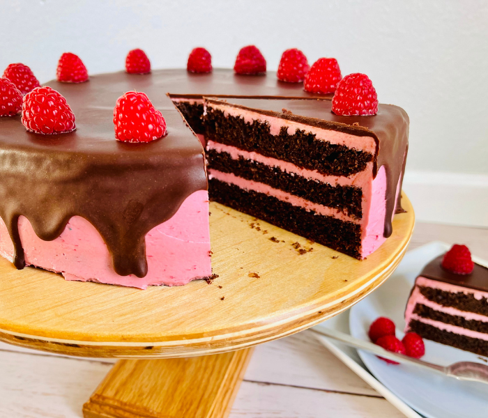 https://mirjamskitchenyodel.com chocolate raspberry cake slice cut out on plate