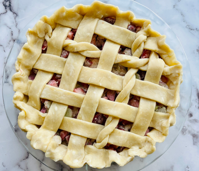 https://mirjamskitchenyodel.com strawberry rhubarb pie close up before baking