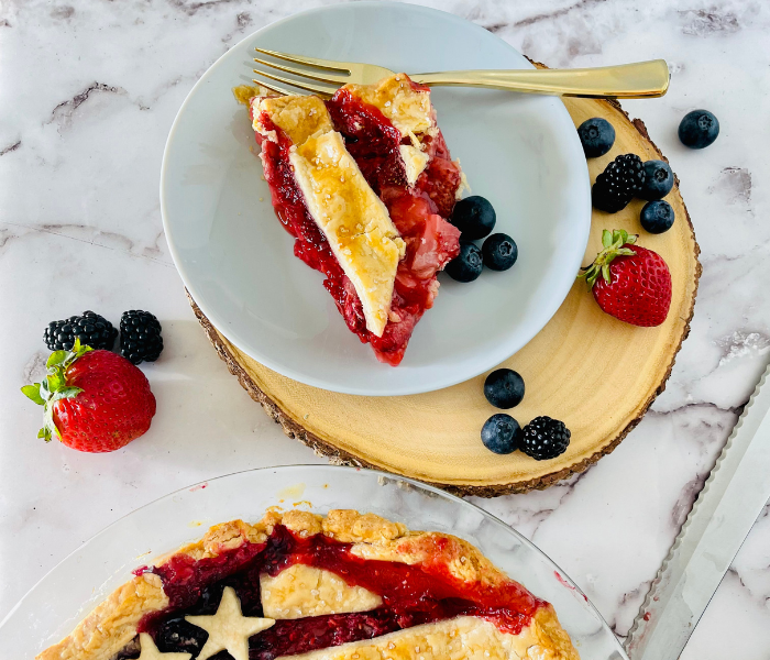 https://mirjamskitchenyodel.com american flag berry pie slice on plate