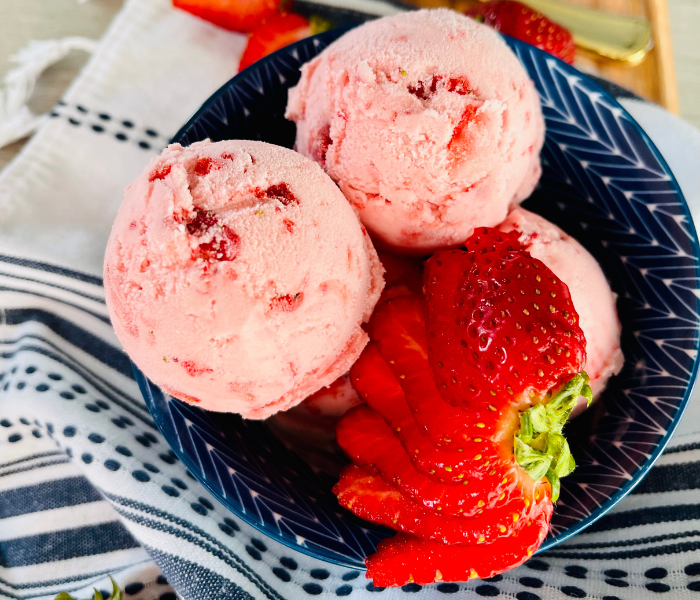https://mirjamskitchenyodel.com strawberry ice cream decorated with fresh strawberry