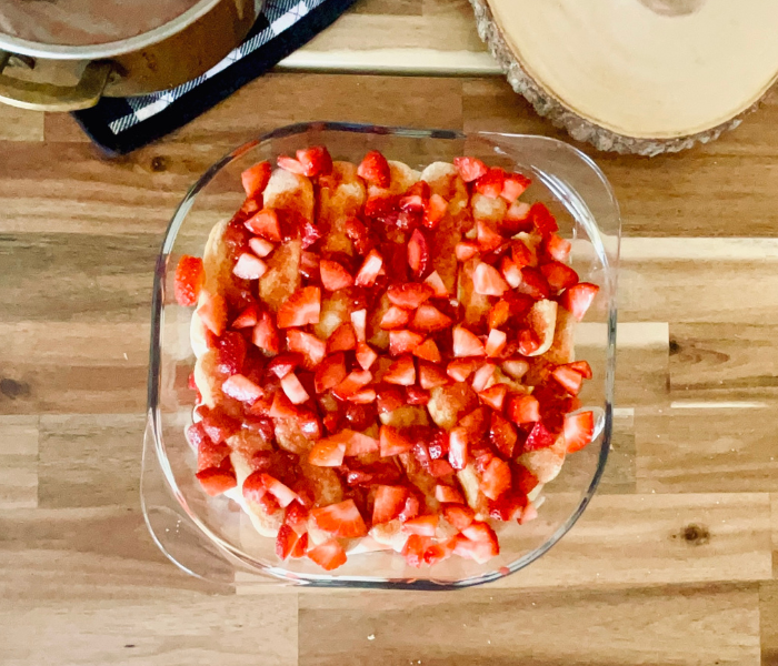 https://mirjamskitchenyodel.com adding strawberries to the tiramisu