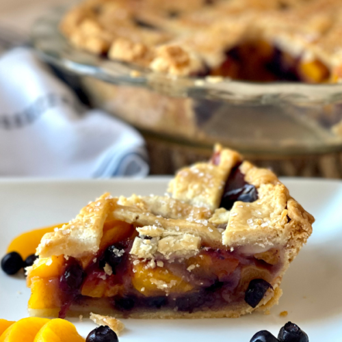 https://mirjamskitchenyodel.com blueberry peach pie slice side view