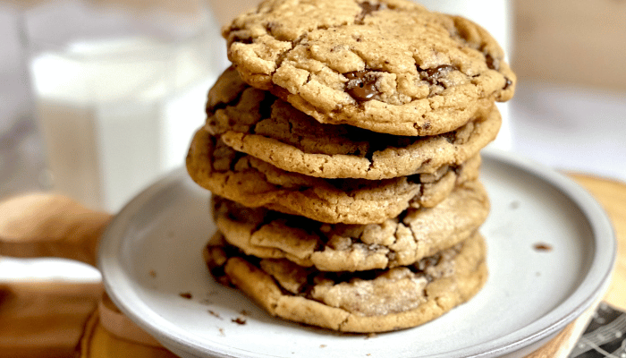 https://mirjamskitchenyodel.com brown butter chocolate chip cookies stacked on top of each other