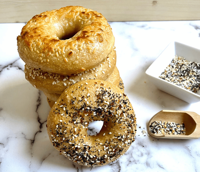 https://mirjamskitchenyodel.com homemade bagels stacked on top of each other