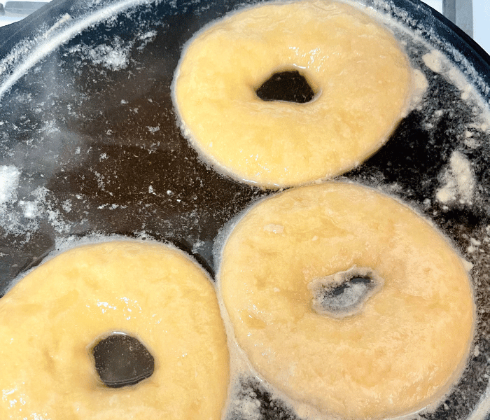 https://mirjamskitchenyodel.com bagels in the water before baking