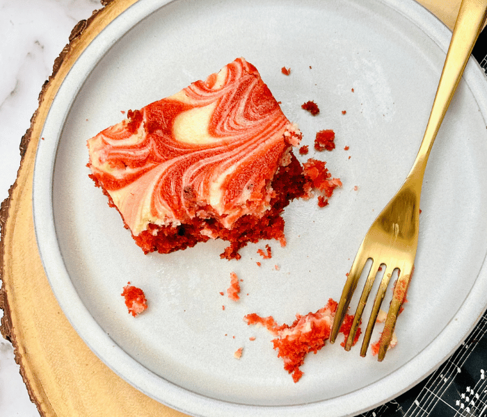 https://mirjamskitchenyodel.com half eaten red velvet cheesecake square