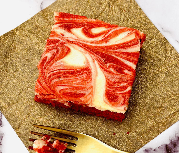https://mirjamskitchenyodel.com red velvet cheesecake square on a gold napkin