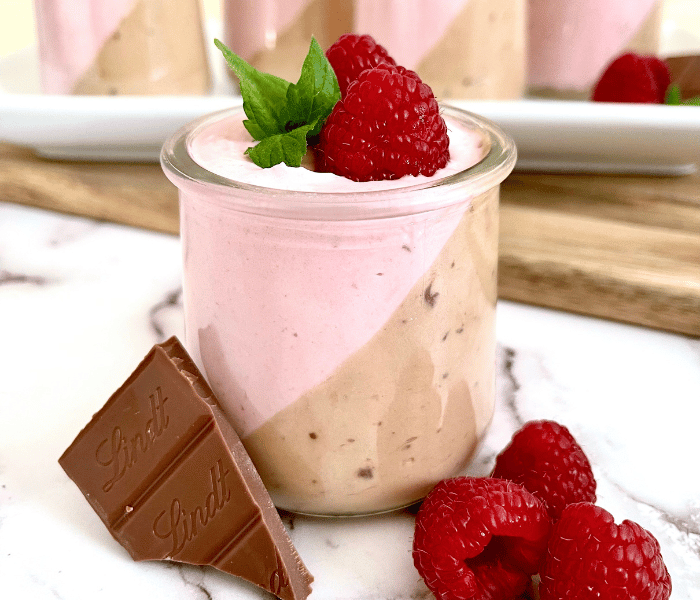 https://mirjamskitchenyodel.com chocolate & raspberry yogurt mousse close up with decoration and lindt chocolate