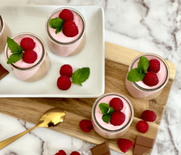 https://mirjamskitchenyodel.com chocolate & raspberry yogurt mousse with decoration. mint leave and raspberries