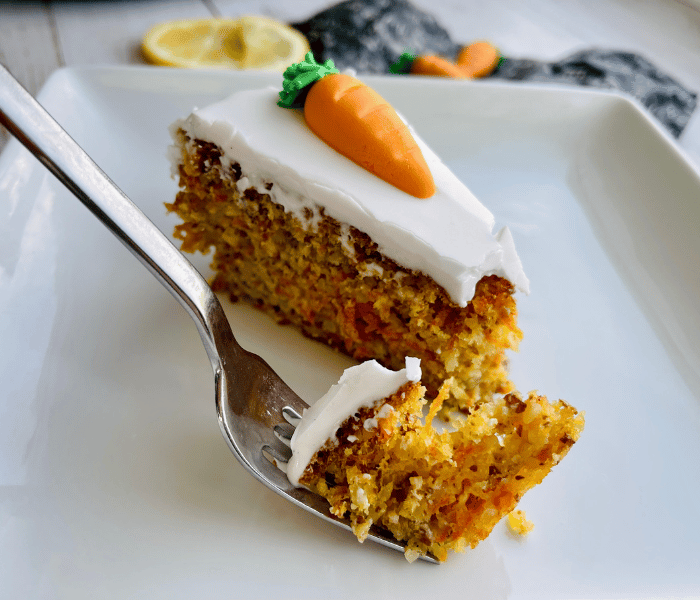 https://mirjamskitchenyodel.com slice of cake with a sugary carrot on it